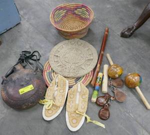 Group of tribal items, baskets, moccasins, pipe, morrocas, etc