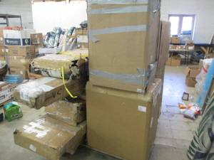 pallet of freezers and wood furnitu...
