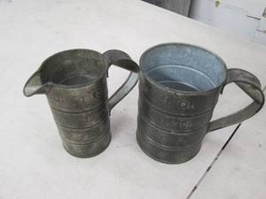 2 vintage metal measuring cups...