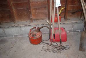 4 metal rakes and 3 gas cans. 2 can...