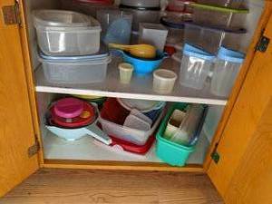 Cupboard loaded with Tupperware and...