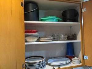Kitchen Cupboard with plates, sauce...