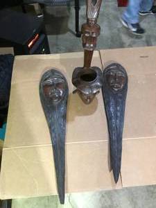 2 hand carved wooden faces and other item