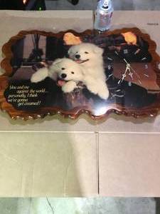 large wooden clock with puppies works