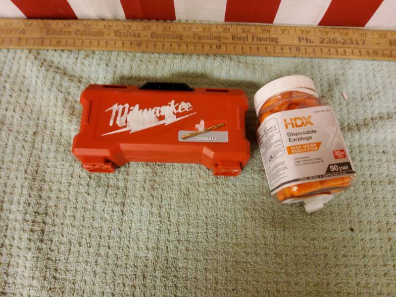 Milwaukee drill bits and full container of ear plugs