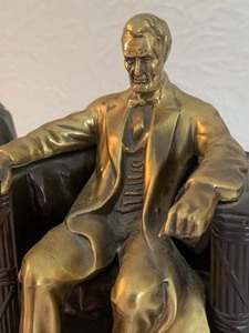 lot 4 image: Pair of Vintage Lincoln Sitting on a Chair Bookends