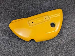 lot 1519 image: NOS - 1973-76 Suzuki TS185 Motorcycle Plastic LH Side Cover - Part No. 47211-29610