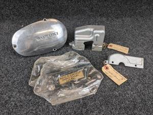 lot 1588 image: Lot of USED Suzuki Oil Pump Covers and Meter Brackets, Part No. 11411-07201, 11411-18000, 11412-18000 and 34950-30020