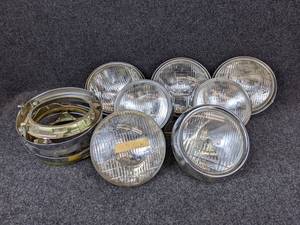 lot 1576 image: Large Lot of Vintage Suzuki Headlamp Assemblies and Bezels