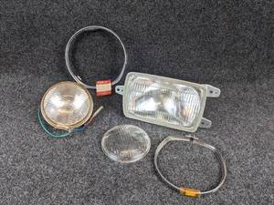 lot 1649 image: NOS - 1972 Suzuki GT750 Headlight Bezel - Part No. 35111-31610 and More