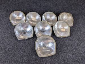 lot 1644 image: NOS - (Lot of 8) 1968-69 Suzuki 150, T200, TC250, TC200 Headlamp Lens Assembly - Part No. 35121-11610