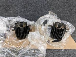 lot 1638 image: NOS 1971 Suzuki T125 RH and LH Cylinder Heads - Part No. 11211-20100 (Has Broken Fins - See pics)  & 11221-20101 -