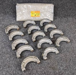 lot 1661 image: NOS - (Lot of 14) 1971-81 Suzuki Motorcycle Brake Shoes - Part No. 54410-35000