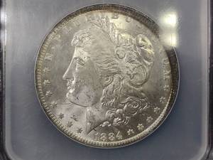 lot 9 image: 1884 O Morgan Silver Dollar, NCS Bi...