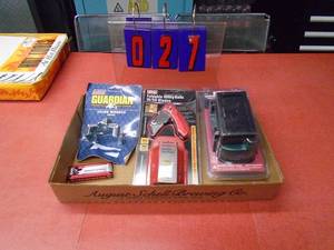 Flat with utility knife, filter wrench & welding goggles. As shown.
