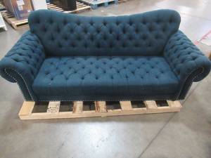 lot 401 image: Noble House Patrick Chesterfield Button Tufted Fabric 3 Seater Sofa, Navy Blue, - Missing Feet. Needs some cleaning, Small Tear on Back RH Corner.