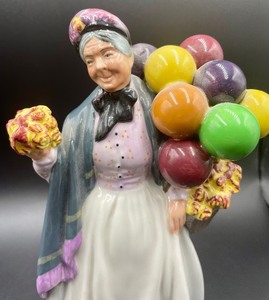 lot 219 image: Royal Doulton Biddy Pennyfarthing Figurine