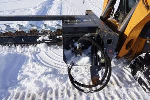 lot 16 image: Brand New Wolverine Universal Mount Bobcat Skid Loader Skid Steer Hydraulic Trencher Attachment