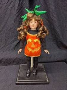 lot 108 image: Paradise Galleries Porcelain Doll in Pumpkin Costume