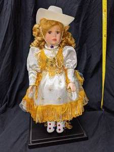 lot 111 image: Collectible Porcelain Western Dolls, 1 is Musical