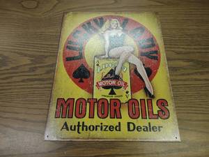 lot 54 image: Lucky Lady Motor Oil Tin Sign, 12.5...