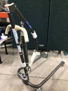 lot 4 image: Probasic Hydraulic Patient Lift supports up to 450 pounds. It features an adjustable width base, a boom that adjusts from 22 to 64 inches, two locking casters and is compatible with a 4- or 6-point sling - Excellent Condition