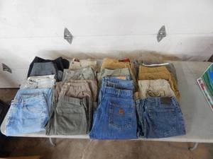 lot 19 image: 17 Pairs Of Size 34 & 36 Pants & Shorts-Carhart, Wrangler, Lee & More