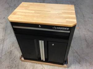 lot 103 image: Ready-to-Assemble 24-Gauge Steel 1-Drawer 2-Door Garage Base Cabinet in Black (28 in. W x 33 in. H x 18 in. D) by Husky Customer Returns See Pictures