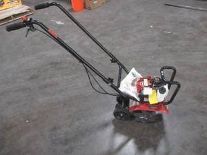 lot 7 image: Honda 9 in. 25 cc 4-Cycle Middle Tine Forward-Rotating Gas Mini Tiller-Cultivator - USED. Could not start - has compression.