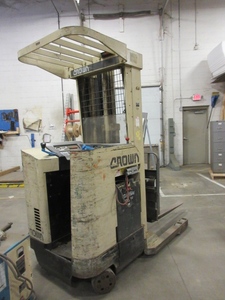 lot 803 image: CROWN STAND UP FORKLIFT WITH BATTERY CHARGER
