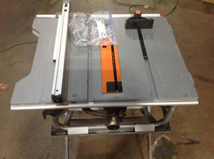 lot 28 image: Ridgid 10-in. table saw with stand in good condition customer returns see pictures