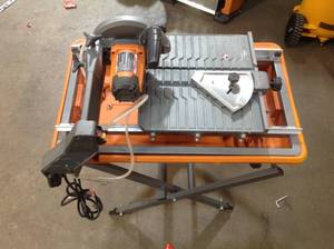 lot 33 image: RIDGID 7 In Wet Tile Saw with Stand open Box in good condition customer returns see pictures