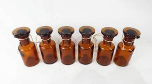 lot 86 image: Set of 6 Vintage Mercer Glass Works Merco 30 ML Amber Glass Flat Top Grooved Stopper Dropping Bottles