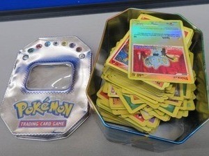 lot 12 image: POKEMON TRADING CARD TIN WITH POKEMON CARDS