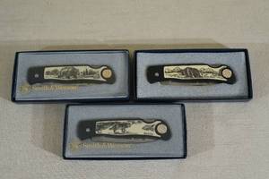 lot 55 image: 3 Smith & Wesson Scrimshaw Design Folding Knives