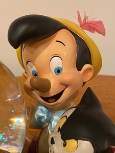 lot 11 image: Whimsical Pinocchio Musical Snow Globe