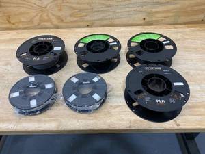 lot 117 image: Lot of 6 Spools of 3D Printer Filament (gray, black and white)