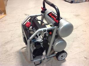 lot 18 image: Husky 4.5 Gal. Portable Electric-Powered Silent Air Compressor in good condition see pictures