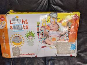 lot 32 image: Bright Starts Playful Pinwheels Bouncer