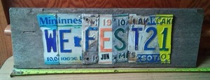 lot 143 image: WE Fest 21 wood and metal sign.