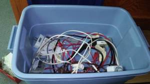 lot 220 image: Tote with electrical extension cords, adapters and more.