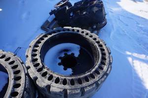 lot 14 image: Cat Brand Solid Skid Loader Tires With 8 Bolt Rims