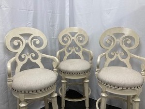 lot 150 image: Three Elegant Wood Upholstered Swivel Bar Stools