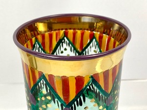 lot 32 image: MacKenzie-Childs Handblown, Hand-Painted Circus Pennant Tumbler and Gift Bag