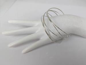 lot 142 image: Tiffany & Co. Sterling Elsa Peretti Wave 5-Row Bangle Bracelet, with Box and Pouch