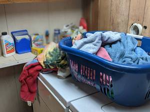 lot 48 image: Laundry basket of towels and househ...