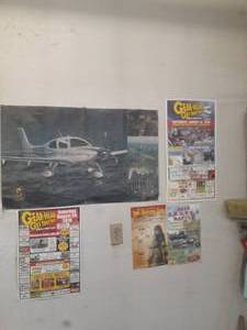 lot 55 image: Poster of Cirrus plane, gearhead ge...