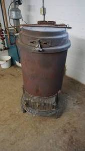 lot 1 image: Cast Iron Coal  Wood Stove--44 Tall  x 24 Round