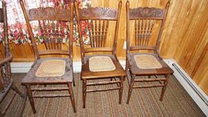 lot 22 image: Three Wooden Kitchen Chairs W Decorative Etching On Top Of The Back Of The Chair--Webbed Inserts On Seats Also