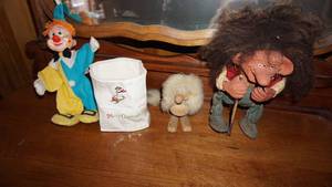 lot 25 image: Four Collectible Articles--Merry Christmas Vase--Clown-- Wooden Puppy With Long Tail--An Old Man With Walking Stick & Brown Hair